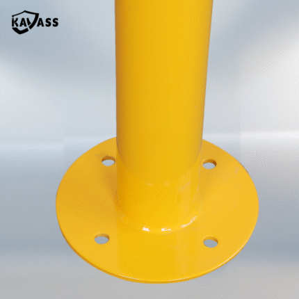 Detailed view of flange base with mounting holes on yellow KAVASS Surface-Mounted Fixed Bollard.