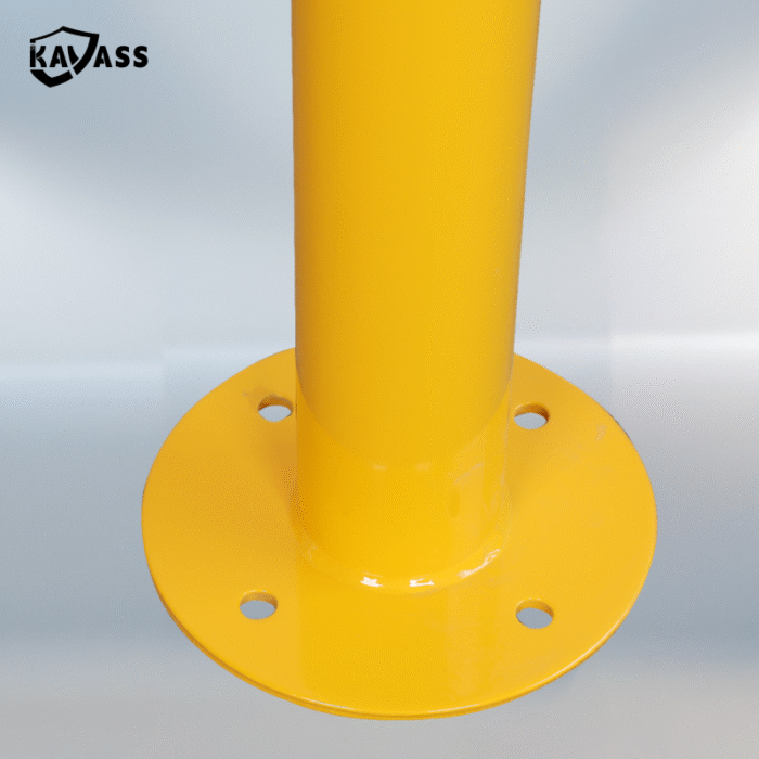 Detailed view of flange base with mounting holes on yellow KAVASS Surface-Mounted Fixed Bollard.