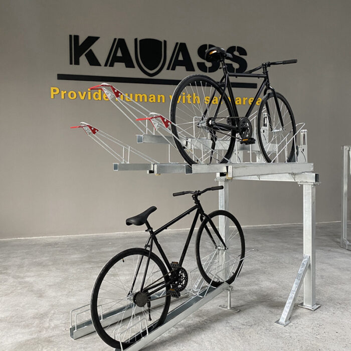 Gas Assist Double Decker Bike Rack with one black bicycle parked on each layer, featuring the 'KAVASS' logo and slogan in the background.