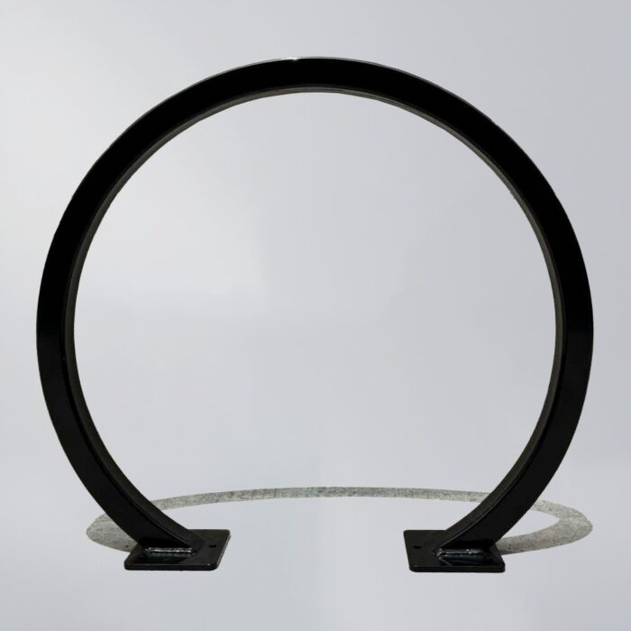 Black square-tube bike rack with a circular layout and square mounting bases, featuring a minimalist design suitable for securing bicycles.