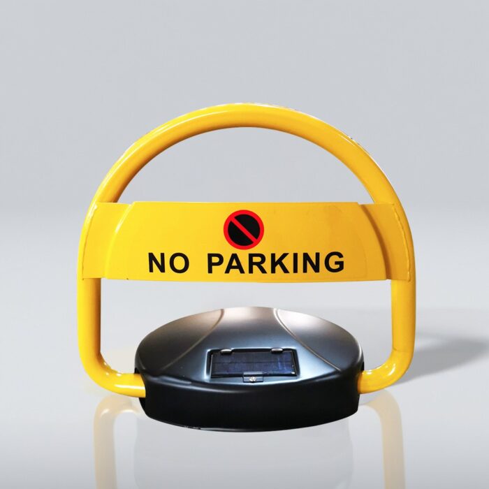 Close-up of solar-powered parking lock, highlighting the bright yellow frame with 'NO PARKING' sign and symbol. Solar panel clearly visible on the black base.