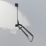 Black metal Swing Wall Mount Bike Rack with simple design, suitable for wall mounting in bicycle storage areas.