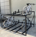 Fixed two-tier 10-slot bike rack without gas assist, installed outdoors for public or institutional use.