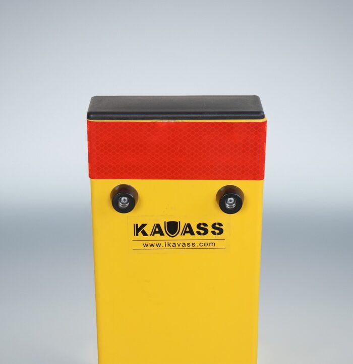 Upper section of folded-down yellow parking bollard, highlighting red reflector and KAVASS branding for visibility.