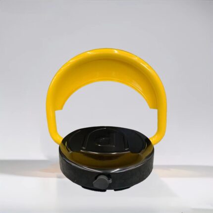 Rear view of yellow D-type remote-controlled parking lock in raised position, powered by dry batteries and equipped with reinforced motor, designed to protect exclusive parking spaces.