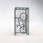 Side view of a blue bicycle suspended and fixed inside a storage mesh locker, showing space-efficient hanging method.