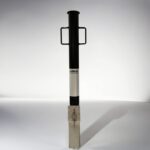 Black and white 89-type underground movable bollard with binaural handle and 'KAVASS' logo, highlighting brand details and padlock-based movement control.