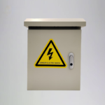 Electrical control box with a ‘DANGER ELECTRIC SHOCK’ sign, likely part of the IoT parking lock power system.