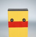 Back-angle close-up of yellow folding bollard’s top section with red reflective strip, focused on enhanced visibility from rear approach.