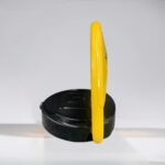 Side angle of yellow D-type remote-controlled parking lock with reinforced motor and dry battery system, intended for managing private parking spaces.