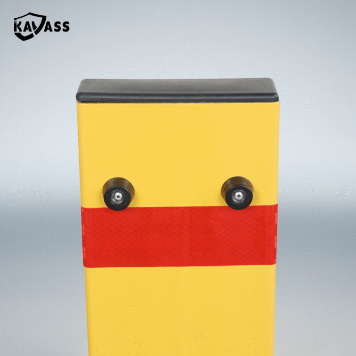 Close-up of yellow folding bollard’s top section with red reflective strip, focused on enhanced visibility .