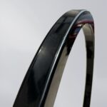 Close-up of the black square-tube surface, highlighting its smooth finish and baked enamel coating for aesthetics and surface protection.