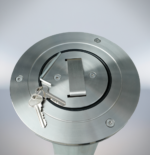 Close-up of the top of a stainless steel telescopic bollard, with keys and a metal tool, showing the unlocking mechanism details.