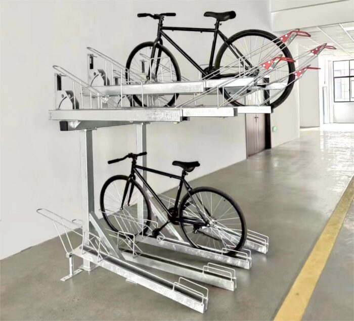 Gas Assist Double Decker Bike Rack, black bicycles parked on both layers, situated in a spacious indoor area with yellow floor markings.