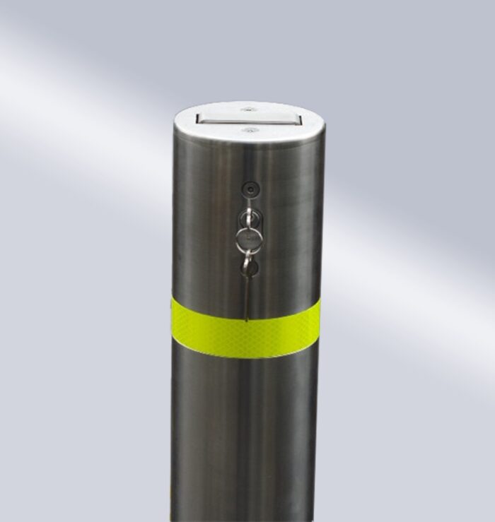 Close-up of stainless steel 114-type bridge-handle underground lock movable bollard with yellow warning band and top lock, designed for easy operation and management.