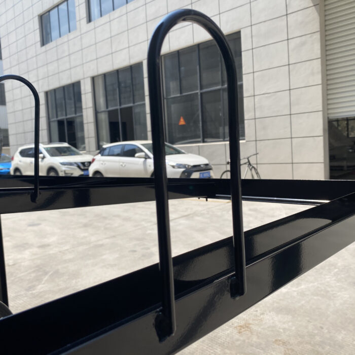 Detail of fixed dual-level bike rack with 10-slot structure, made of steel, for commercial applications without gas assist.