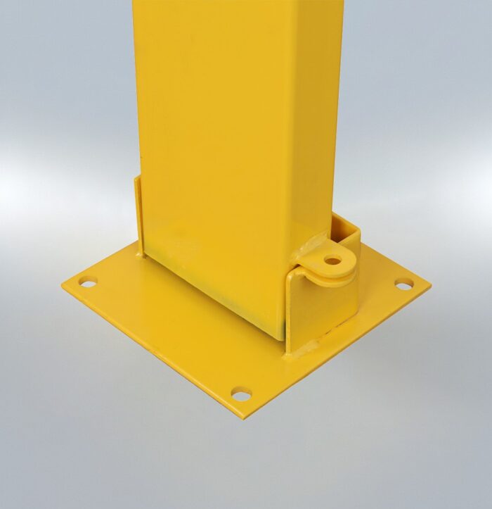 Zoomed-in detail of base-mounted padlock on yellow foldable bollard, showing manual security locking system.
