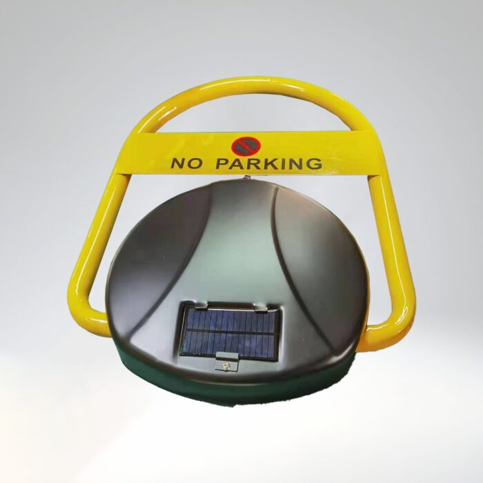 Top-down angled view of solar-powered remote parking lock, showing black base with solar panel and yellow arm with 'NO PARKING' sign and symbol.