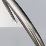 Close-up of 316 stainless steel surface-mounted hoop bike rack, focusing on the metal pipe craftsmanship and durable build quality.