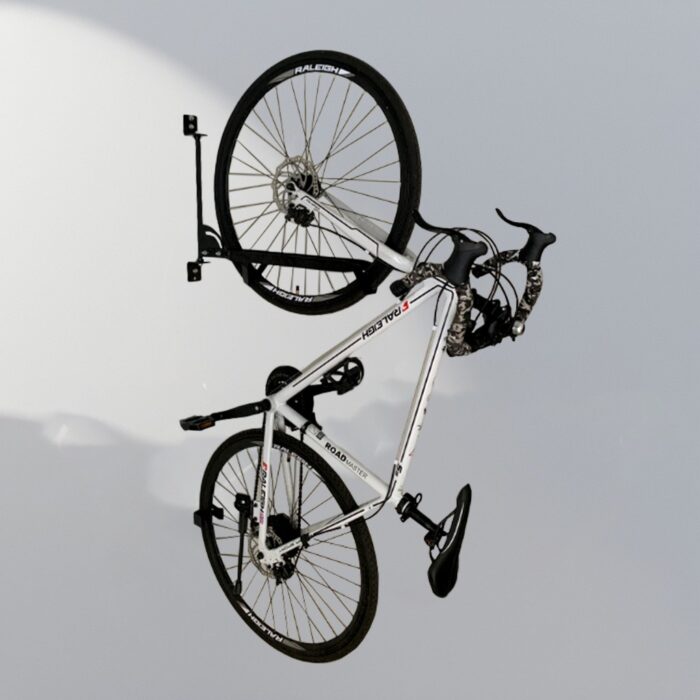 White bicycle mounted on Swing Wall Mount Bike Rack, showing space-saving wall installation in use.