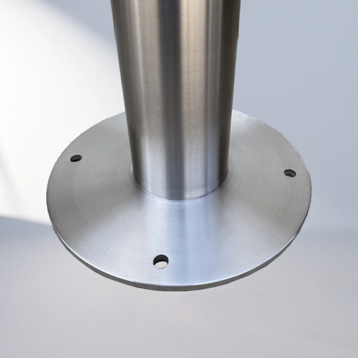 Close-up of the circular base of a stainless steel D-type bollard bike rack, showing mounting holes for secure ground installation.