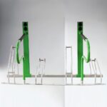 Green metal e-bike parking rack with black handles, designed to securely hold electric bicycles.
