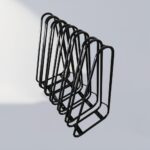 Multiple black triangular wall-mounted bike racks neatly arranged, suitable for indoor and outdoor use, offering space-saving and visually clean bicycle storage.