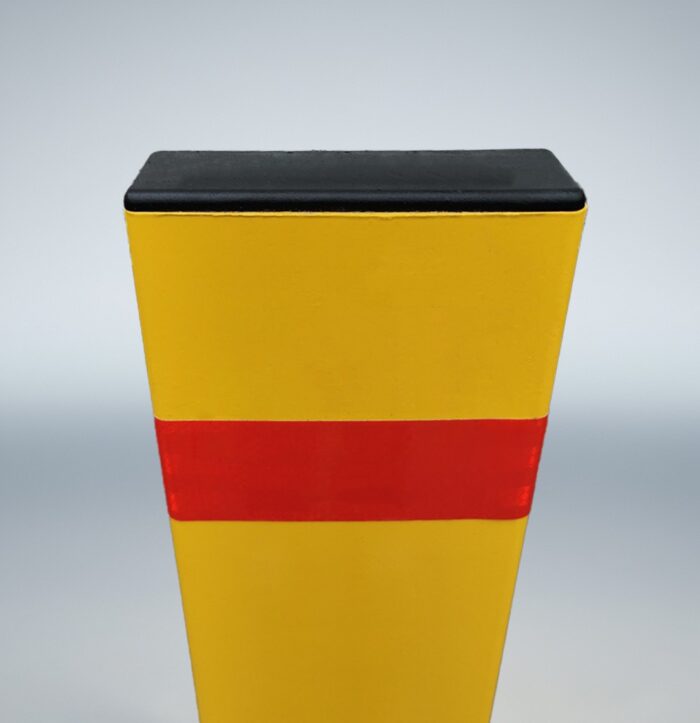 Rear top detail of square bollard, featuring red warning tape and molded plastic cap for rear-side identification.