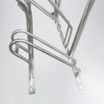 Partial view of Triangle stand bike rack with handles, showing galvanized steel frame and fastening components.