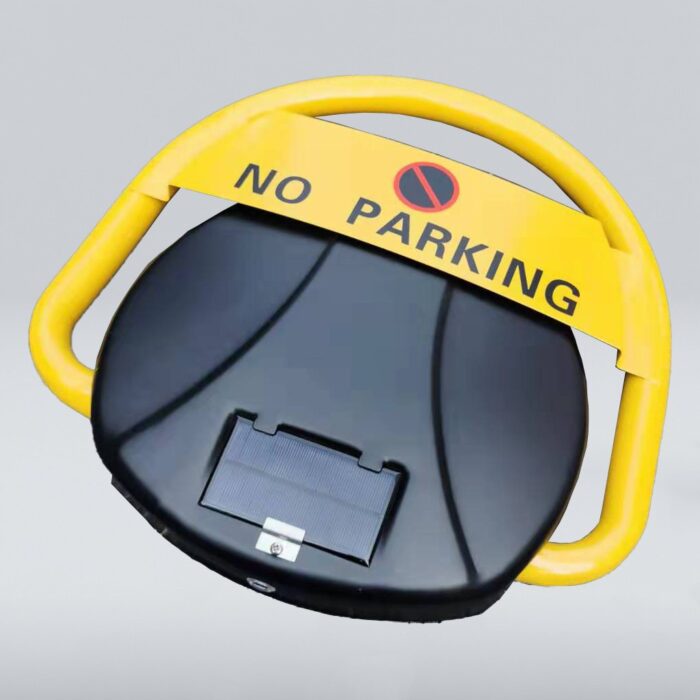 Top-down view of solar-powered parking lock, showing black base with solar panel and yellow cover featuring 'NO PARKING' sign and symbol.